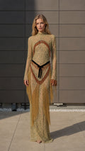 Front view of model wearing gold metallic crochet fringe maxi dress