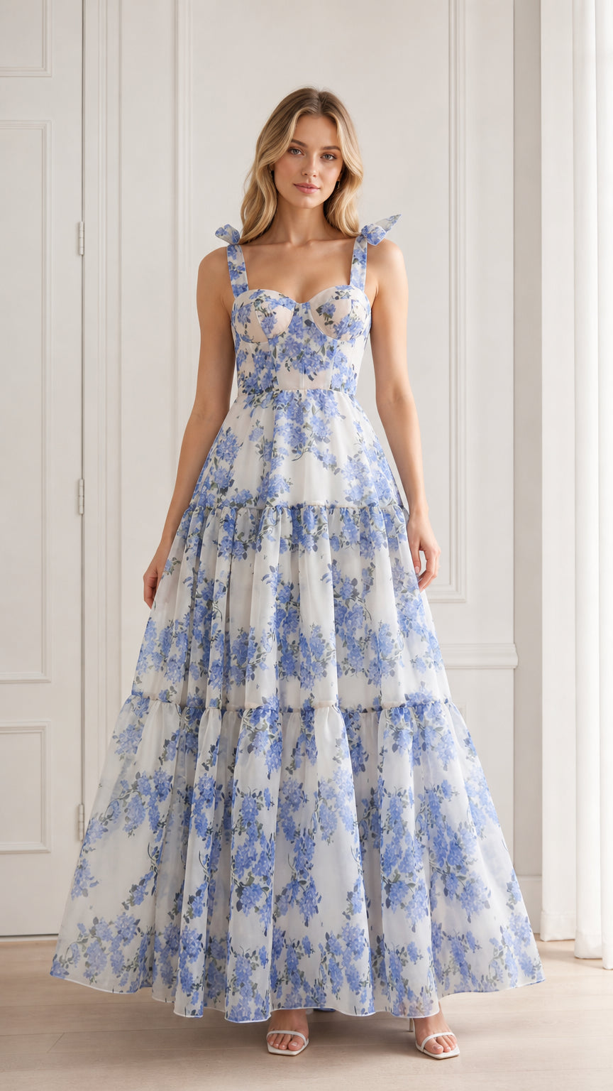 Front view of model wearing blue floral tie strap maxi dress