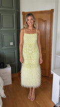 Front view of yellow pearl beaded midi dress with feather hem