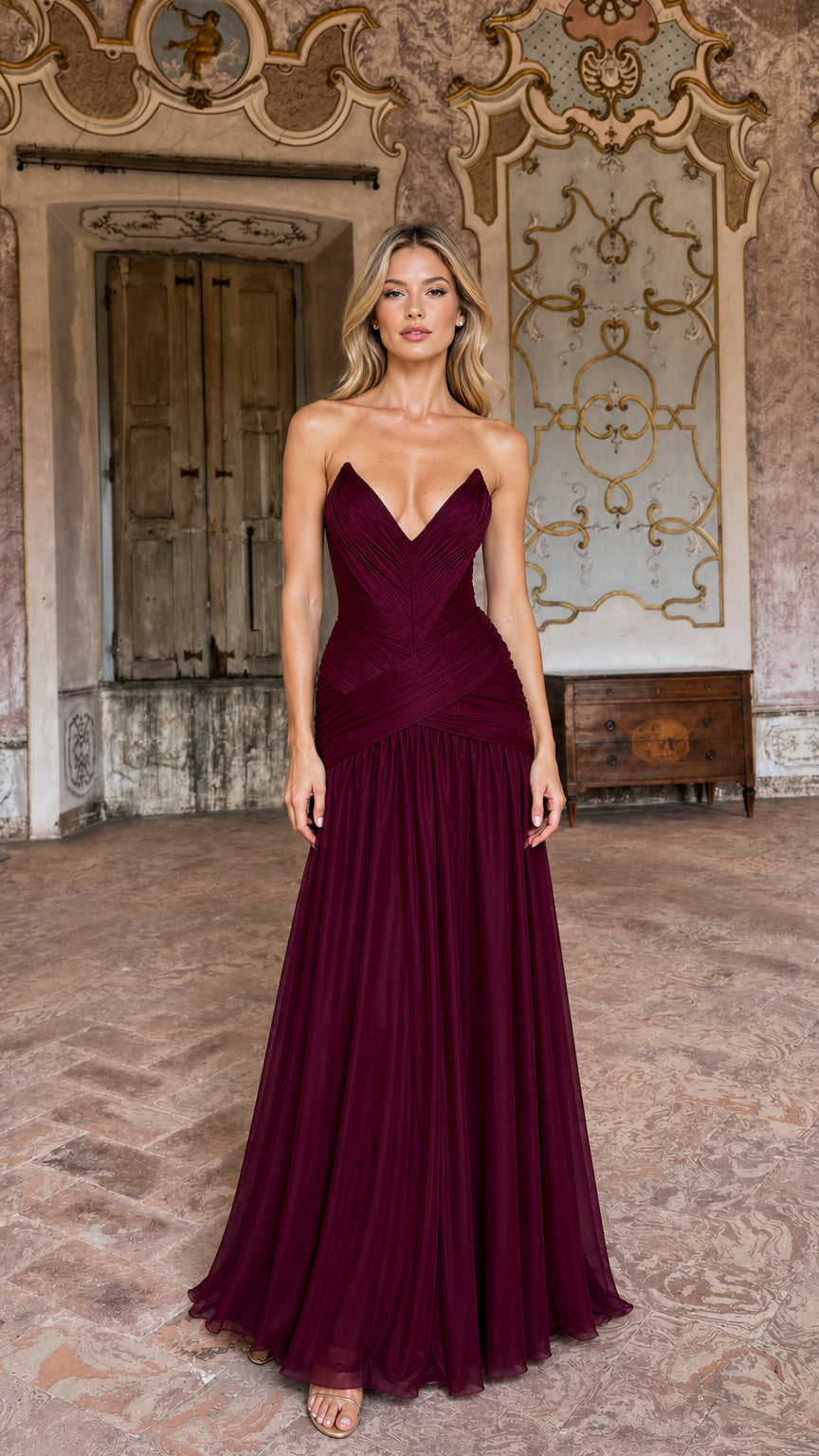 Front view of model wearing burgundy strapless ruched evening maxi dress