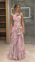 Front view of model wearing pink abstract print halter maxi dress