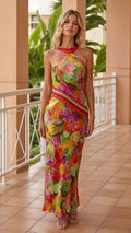 Front view of model wearing yellow floral halter neck maxi dress