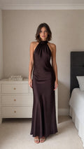 Model wearing dark brown satin halter neck maxi dress front view