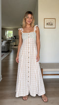 Front full view of woman wearing beige gingham maxi dress