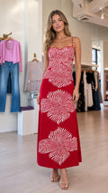 Front view of model wearing red abstract sunburst print maxi dress