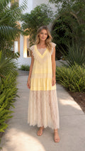 Front view of model wearing yellow lace tiered maxi dress