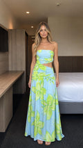 Model wearing blue floral strapless cutout maxi dress, front view