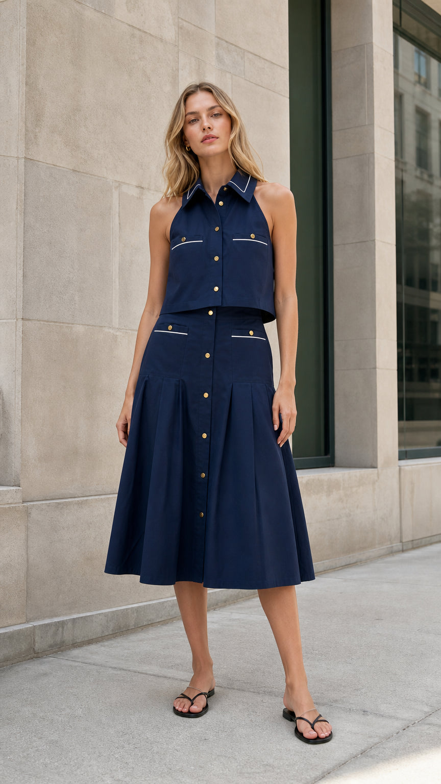 Navy sleeveless collared top and pleated midi skirt set shown from the front
