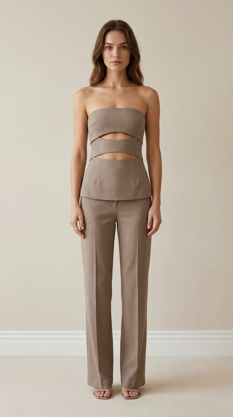 Front view of model wearing taupe strapless cut-out top and trousers set