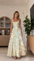 Front view of model wearing champagne sequin maxi dress