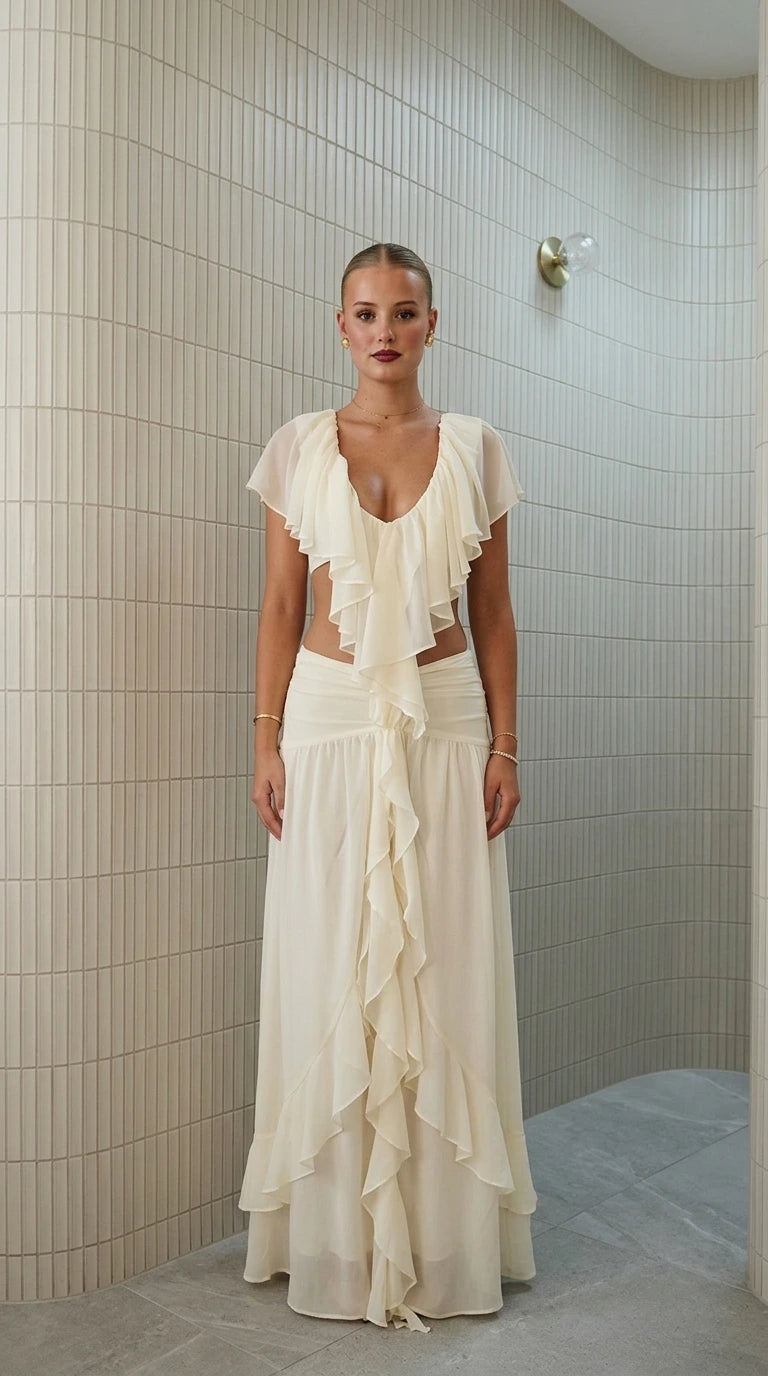 Front view of model wearing ivory ruffled two-piece maxi set
