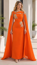 Front view of woman wearing orange evening dress with cape