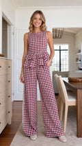 Front view of model wearing burgundy gingham peplum top and wide leg pants set