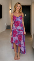 Model wearing purple floral print asymmetric midi dress from front
