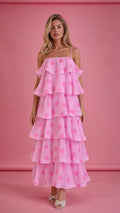 Front view of model wearing pink polka dot tiered ruffle midi dress