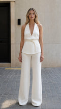 Front view of model wearing white halter top and wide leg pants set