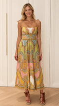 Front view of model wearing multi-color paisley tie-strap midi dress