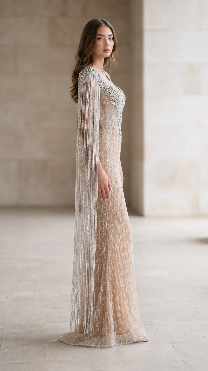 Side profile view of nude evening gown with cape sleeves
