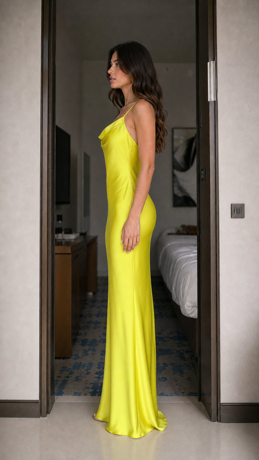 Side profile of model in yellow satin maxi dress