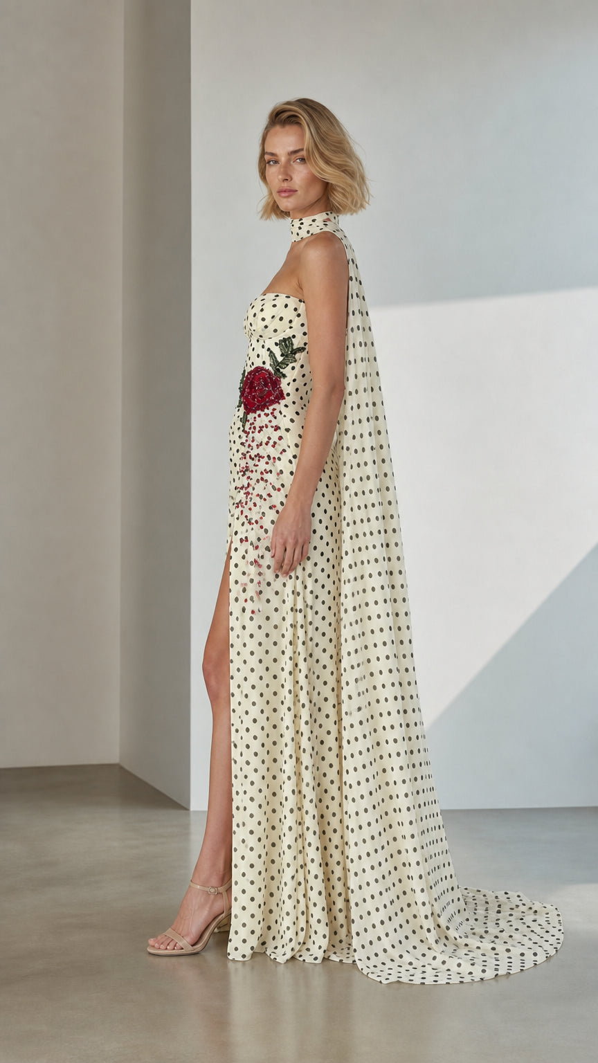 Side profile of White Polka Dot Cape Evening Gown with high slit