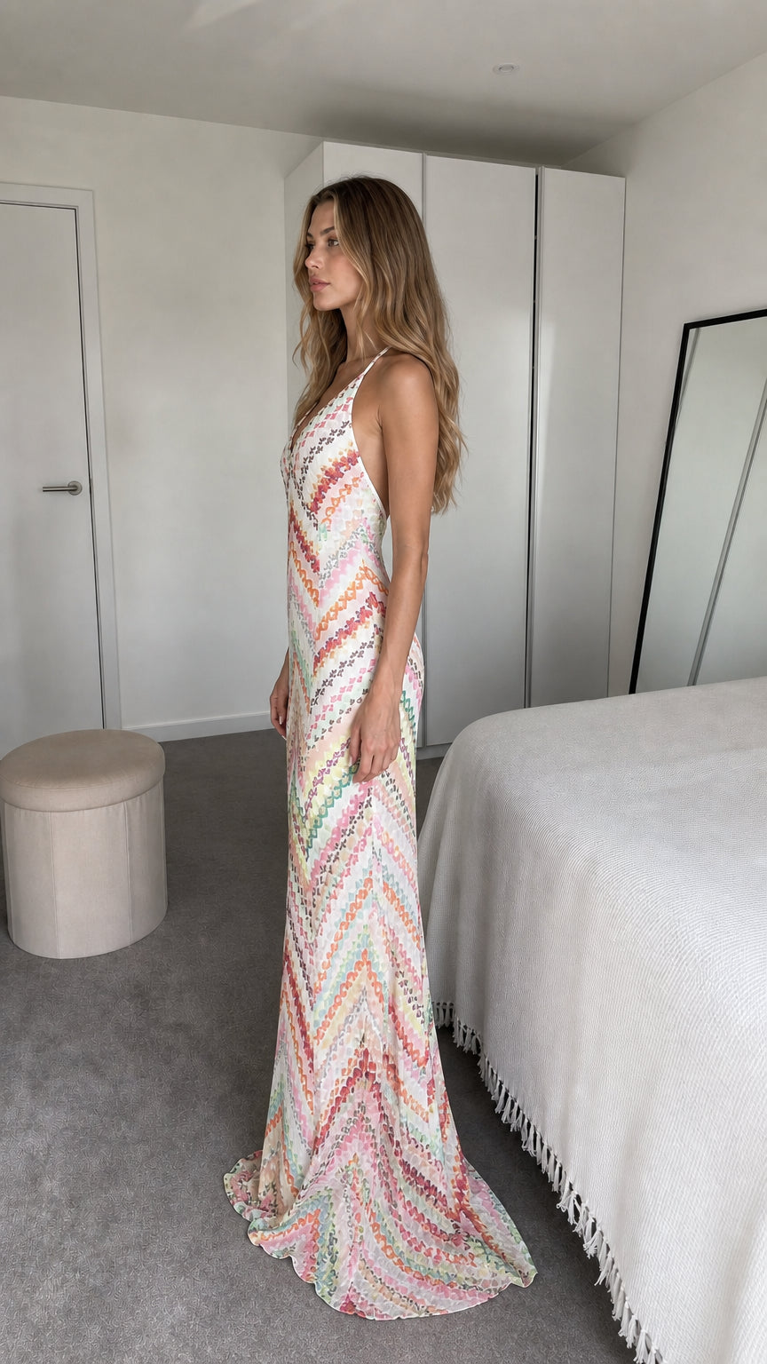 Side view of model wearing white chevron maxi dress