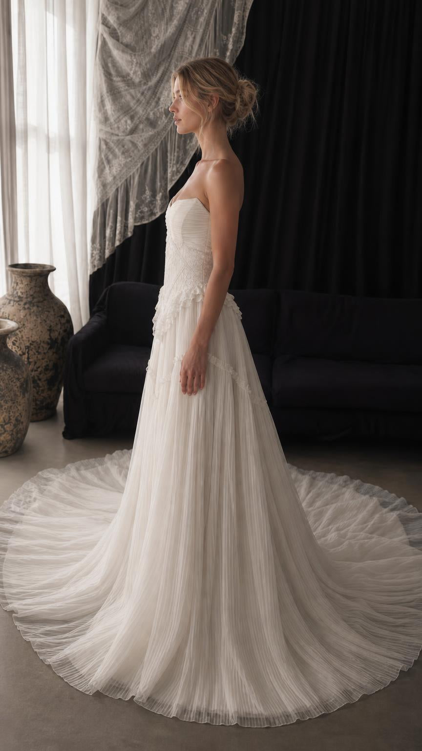 Side profile view of white strapless tulle gown with train