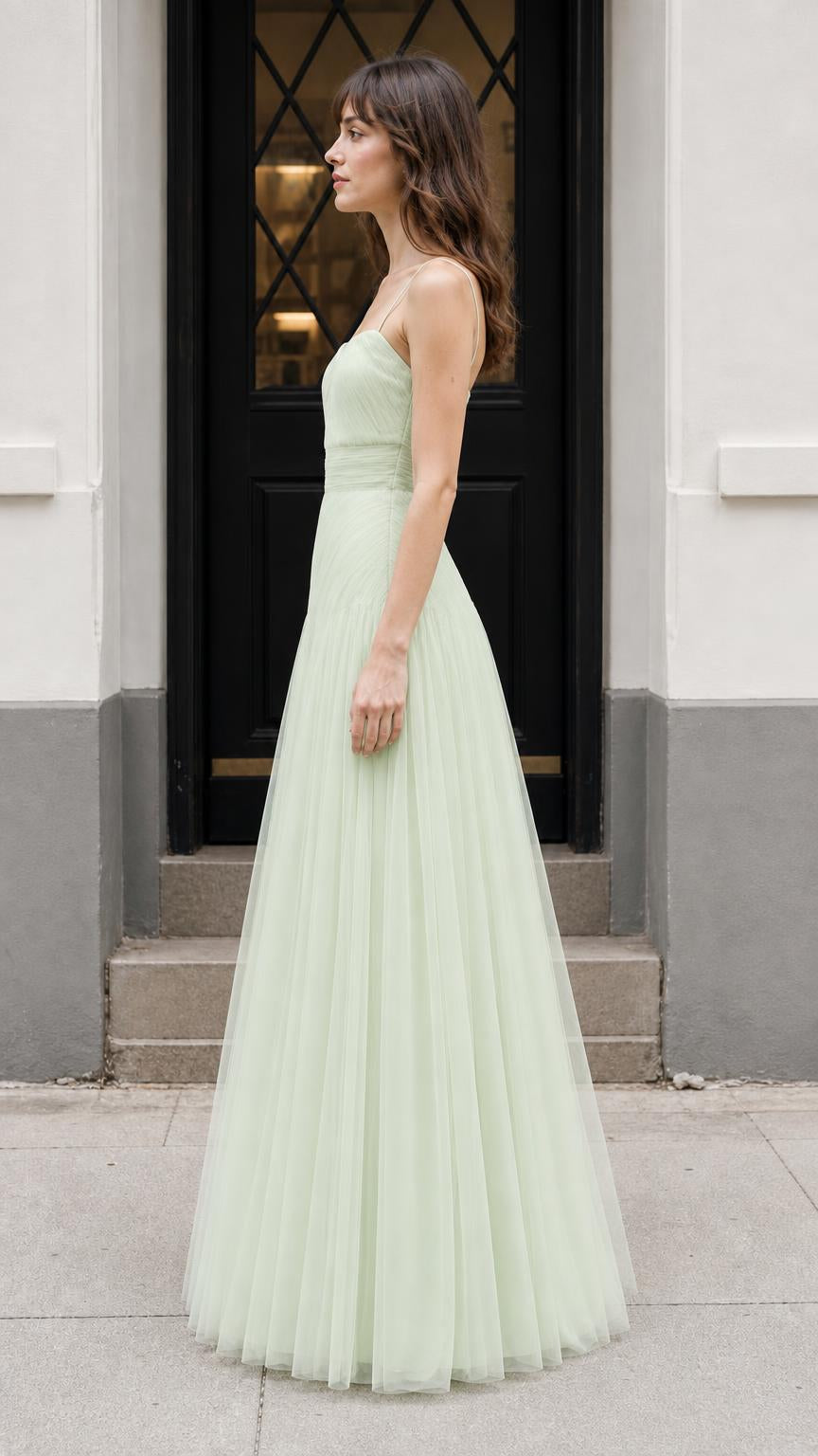 Side profile of model in sage green evening gown