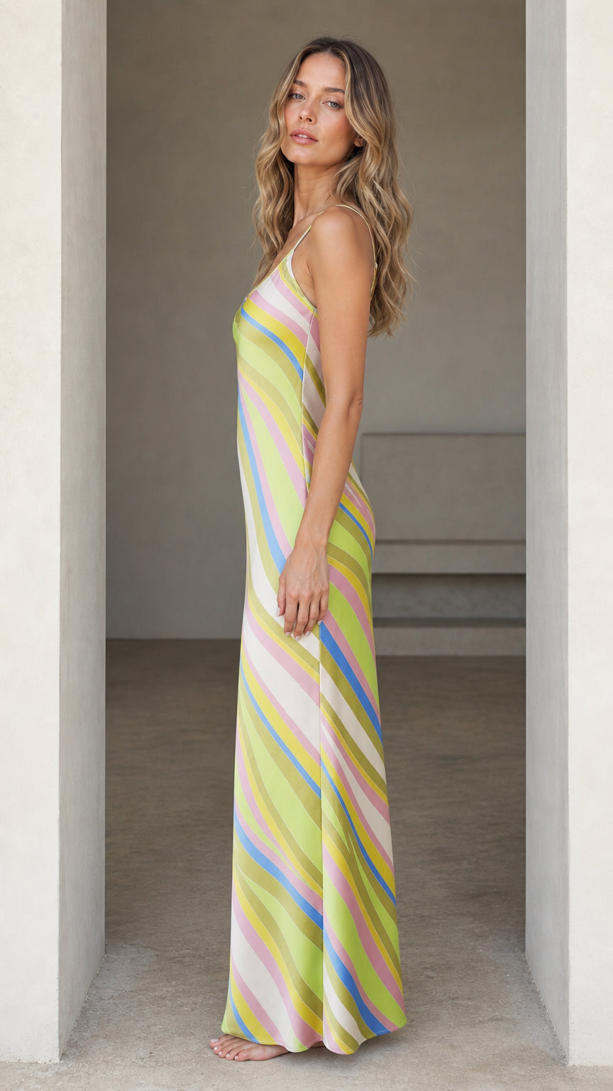 Side profile of woman wearing Lime Multi striped maxi slip dress