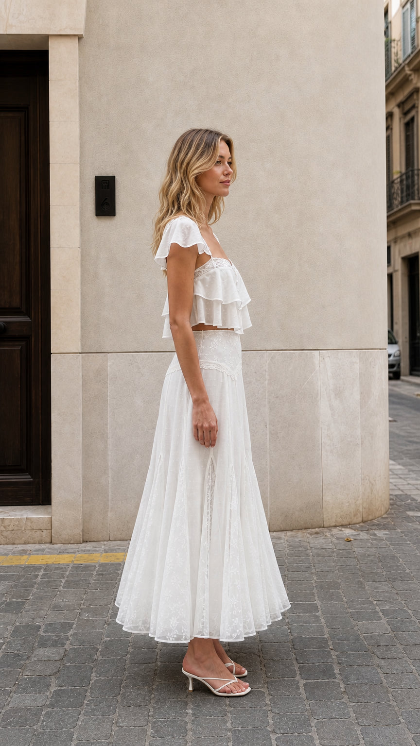 Side view of woman wearing white ruffled two-piece maxi set