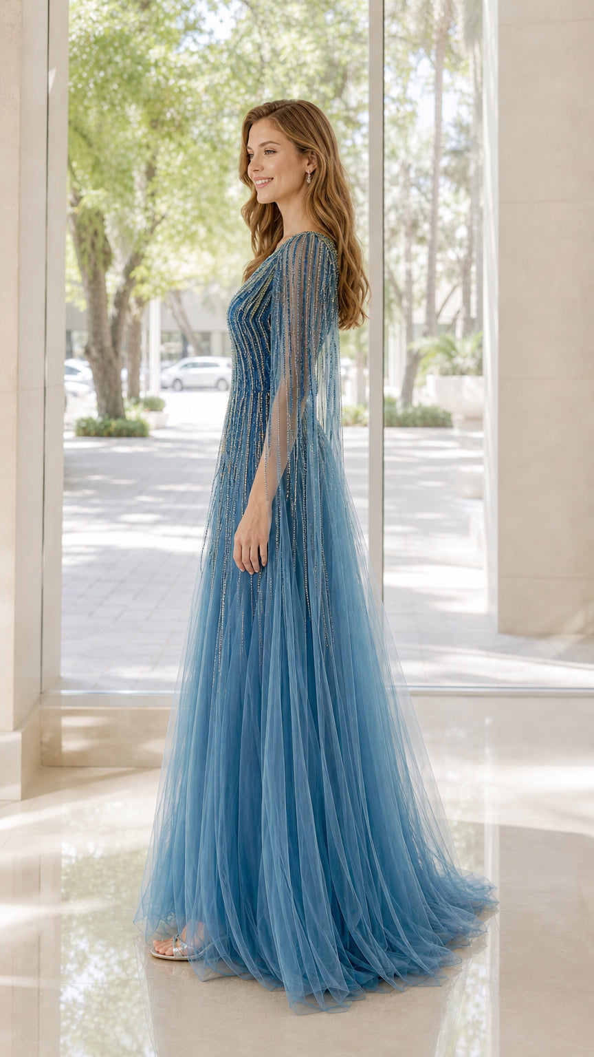 Side view of model wearing blue one-shoulder beaded gown