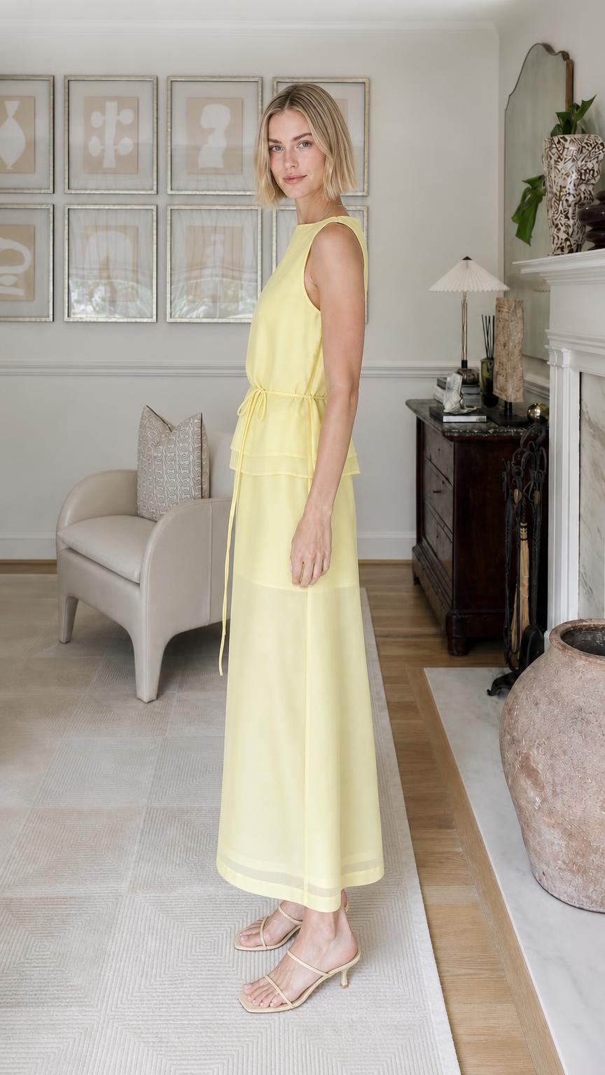 Side profile view of yellow tiered maxi dress