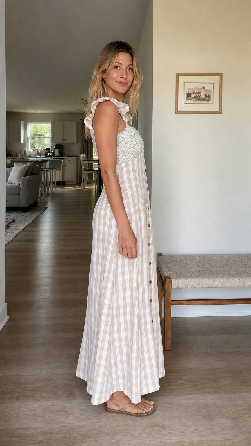 Side profile of woman wearing beige gingham maxi dress