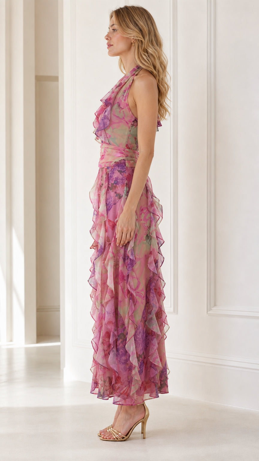 Side profile of model in pink floral halter maxi dress