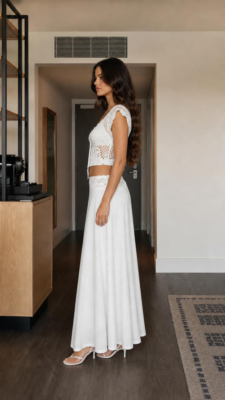 Side profile of model wearing white crochet matching set