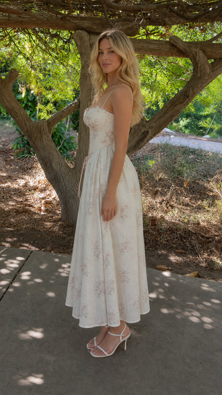 Side profile view of woman in white floral midi dress