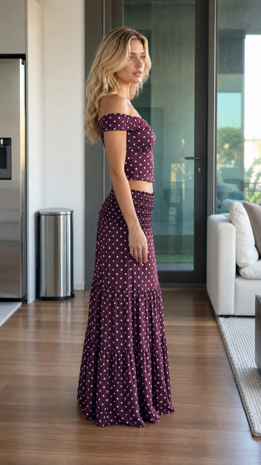 Side profile of model wearing burgundy two piece set