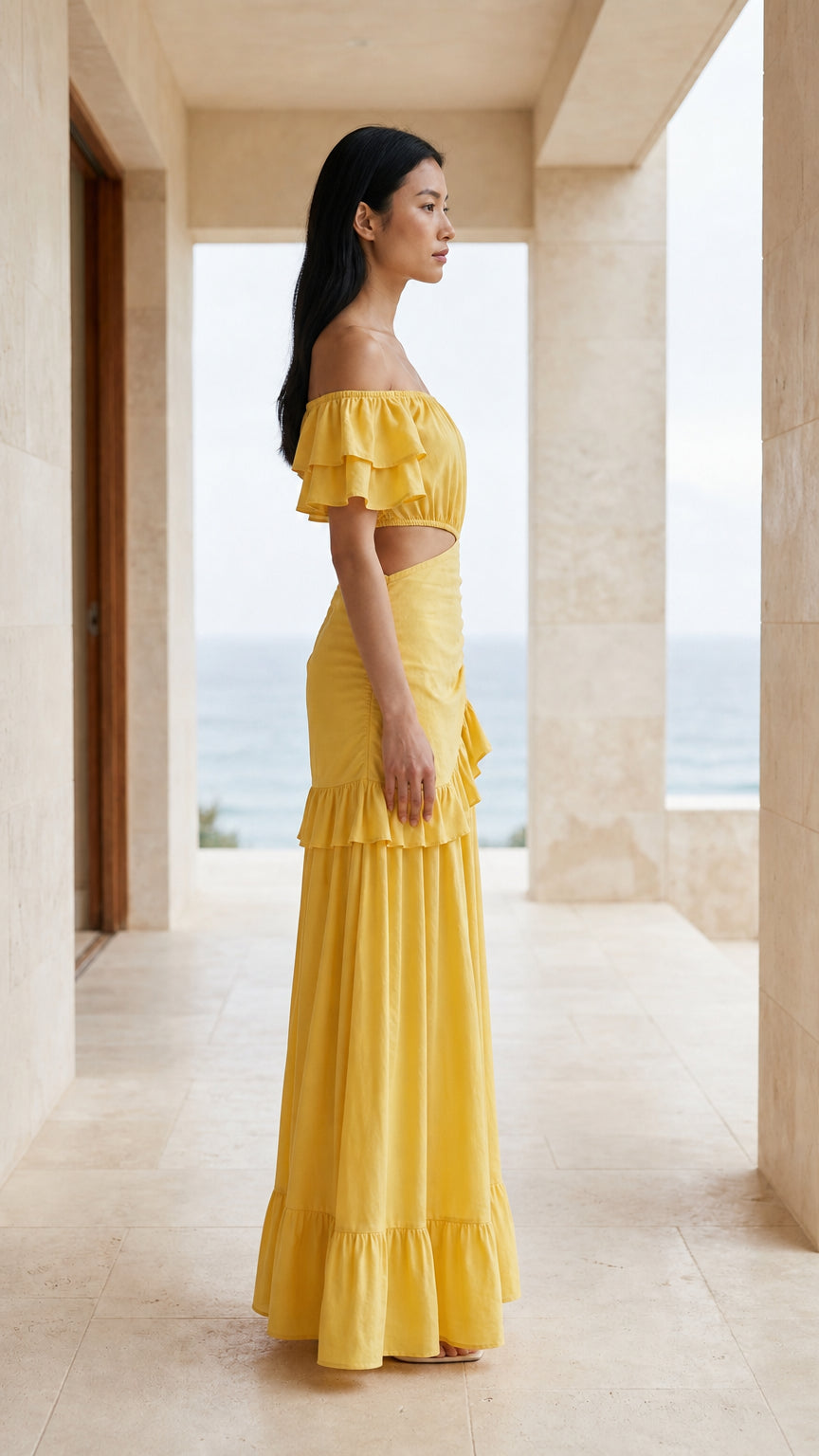 Side profile view of yellow off-shoulder ruffle maxi dress