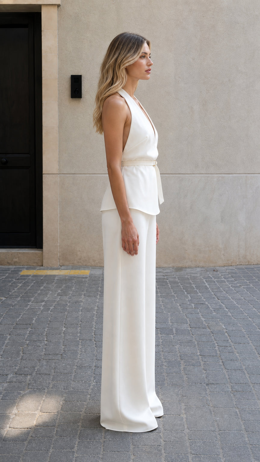 Side profile view of model in white two-piece pants set