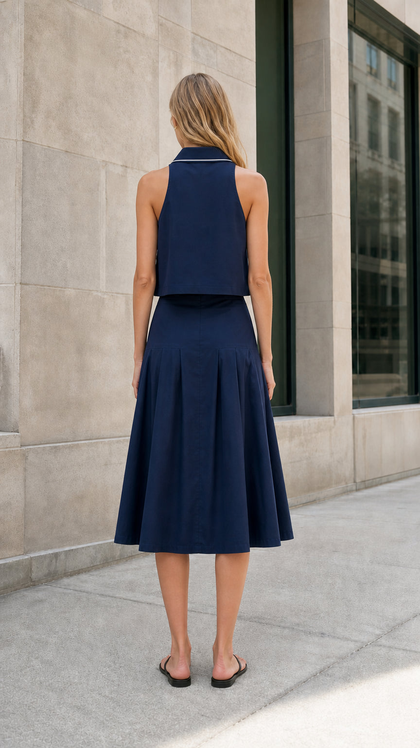 Navy sleeveless midi skirt set shown from the back
