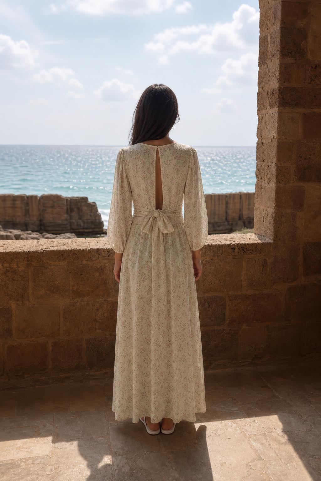 Back view of cream maxi dress showing open back and tie detail
