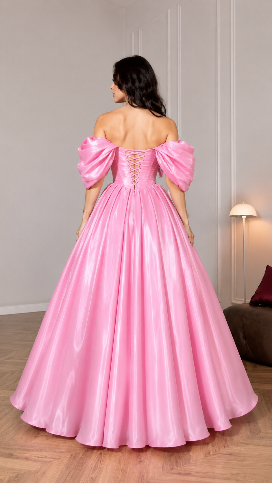 Back view of pink ball gown featuring lace-up back and dramatic full skirt
