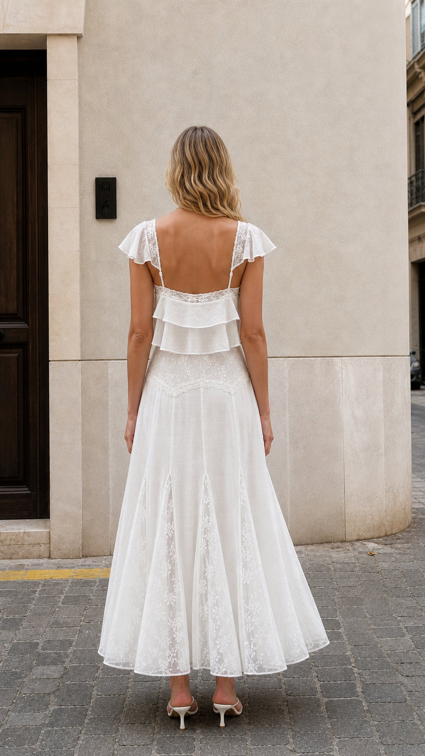 Back view of woman wearing white ruffled two-piece maxi set