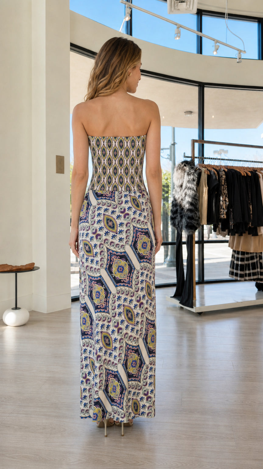 Back view of woman wearing white multi boho printed strapless maxi dress