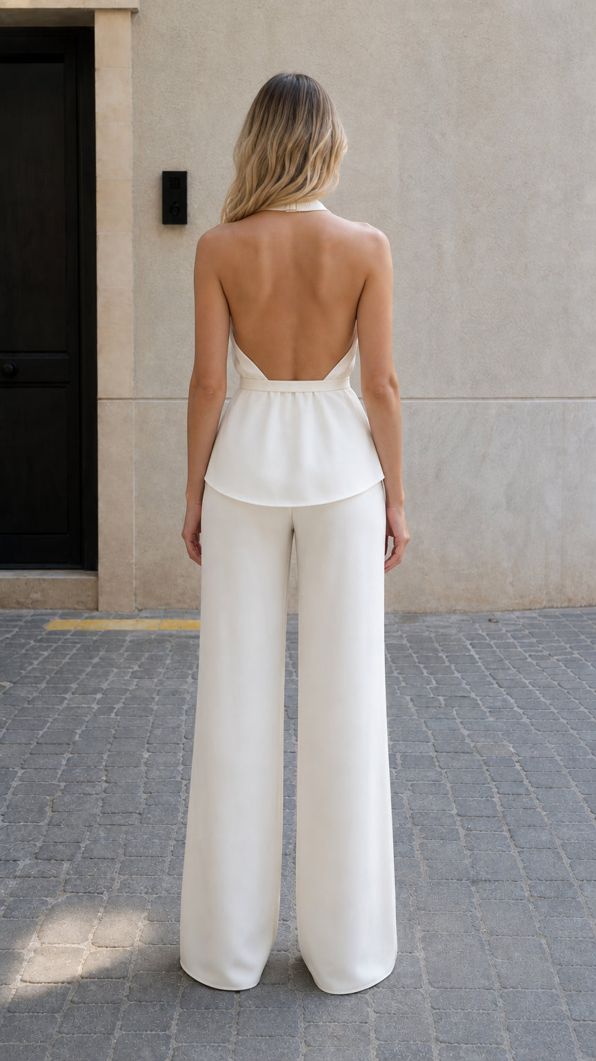 Back view of model showing open back design of white halter top
