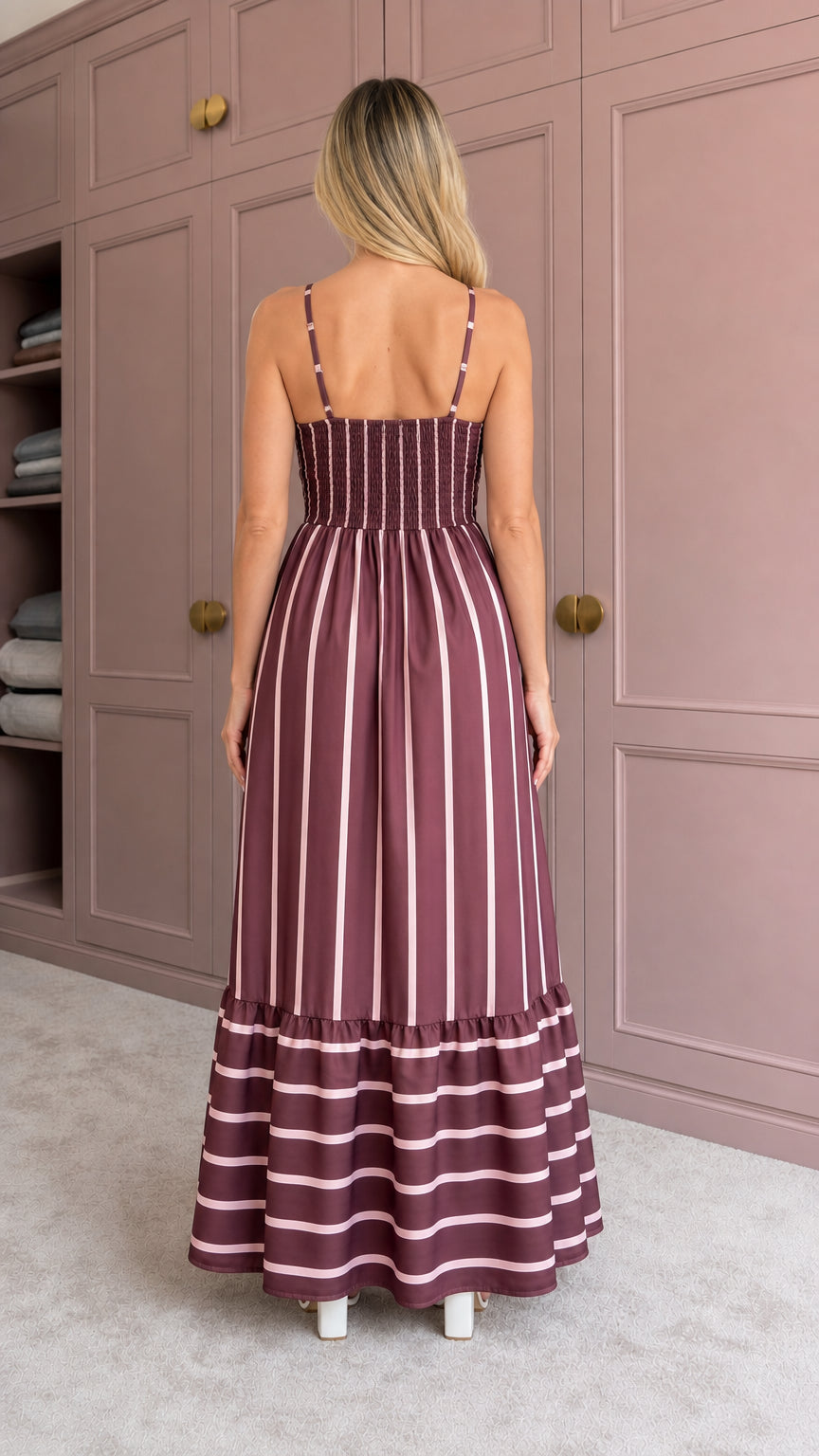 Woman wearing burgundy striped maxi dress back view showing smocked detail