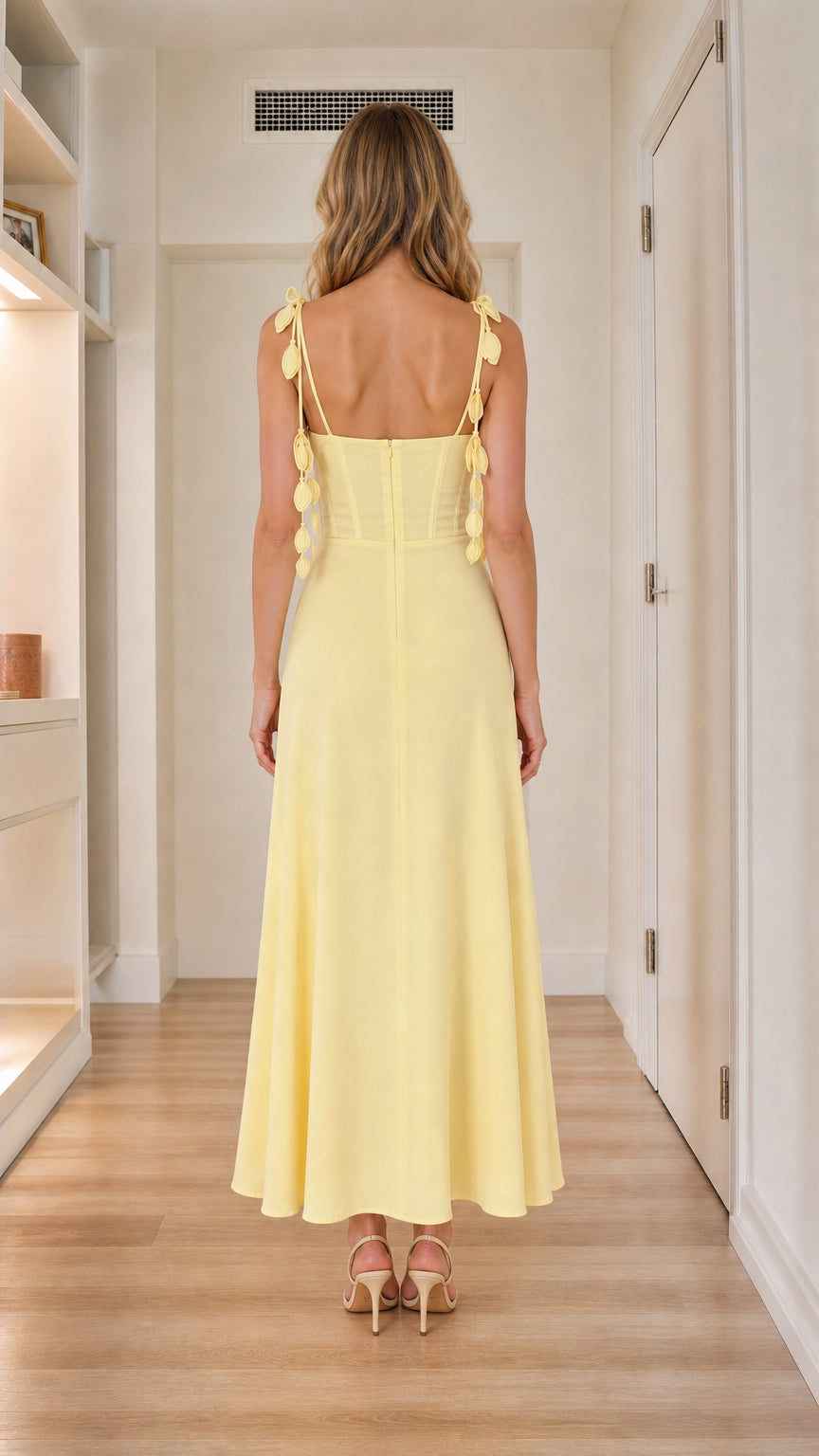 Back view of yellow corset maxi dress showing bow details