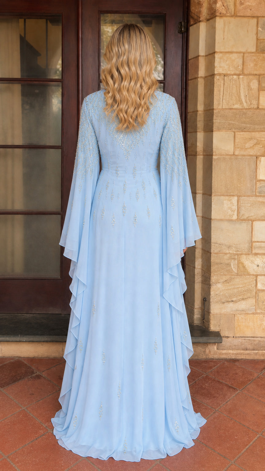 Model wearing light blue beaded maxi dress back view