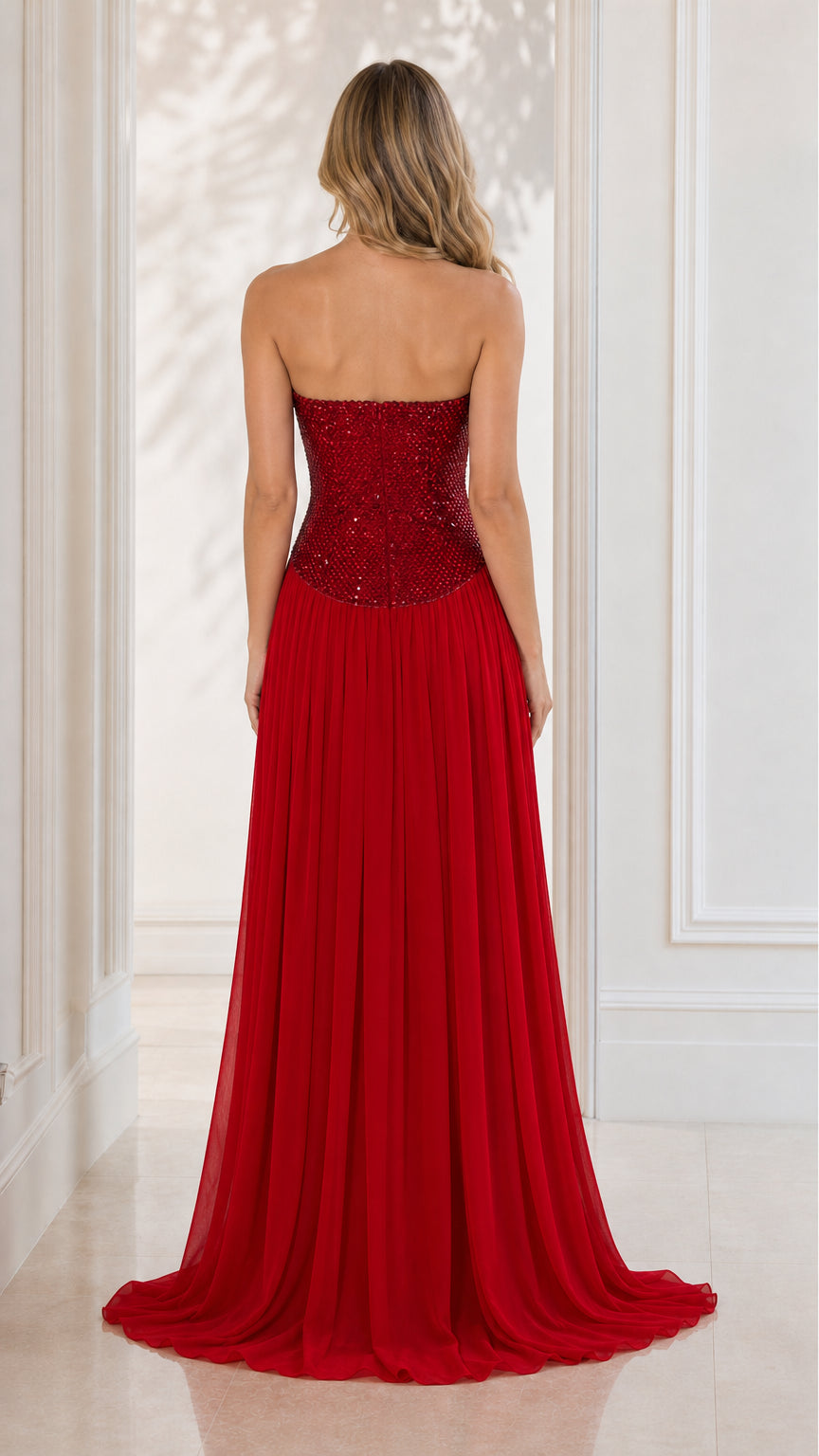 Back view showing sweeping chiffon train of red evening dress