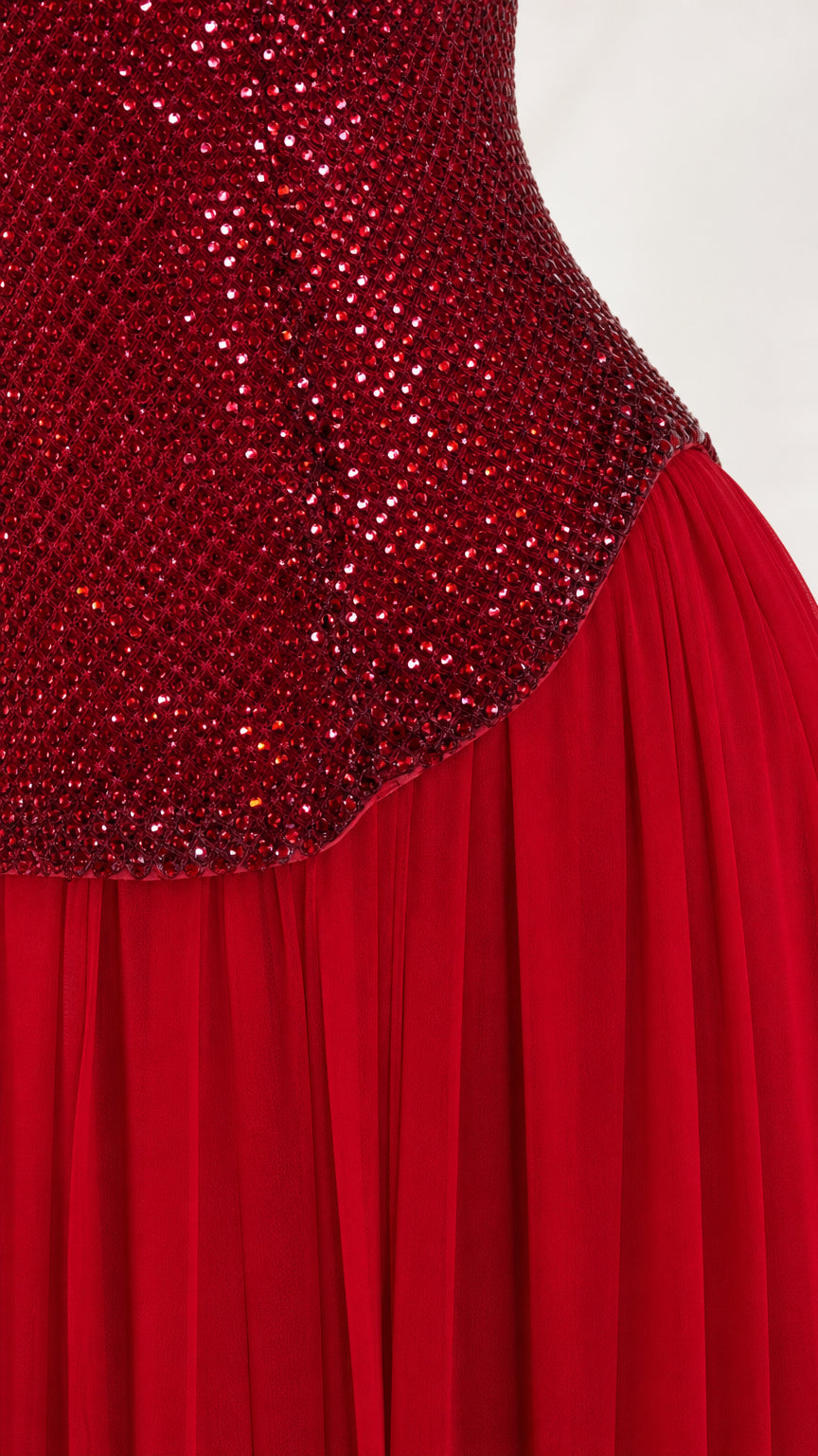 Close-up detail of red sequin bodice texture and pleating