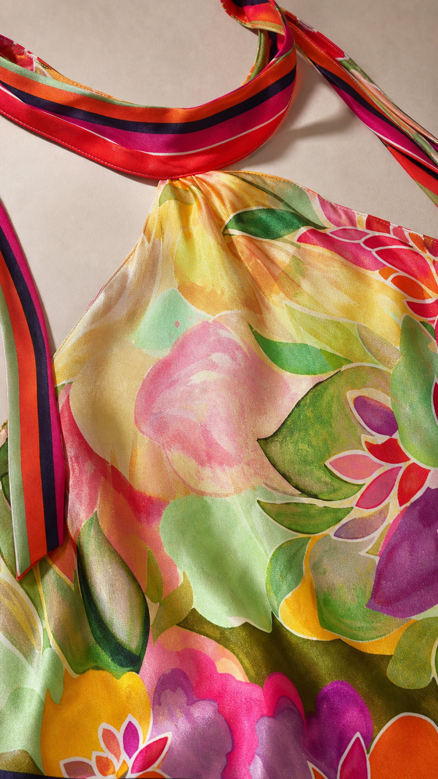Close-up detail of halter neckline and floral fabric texture
